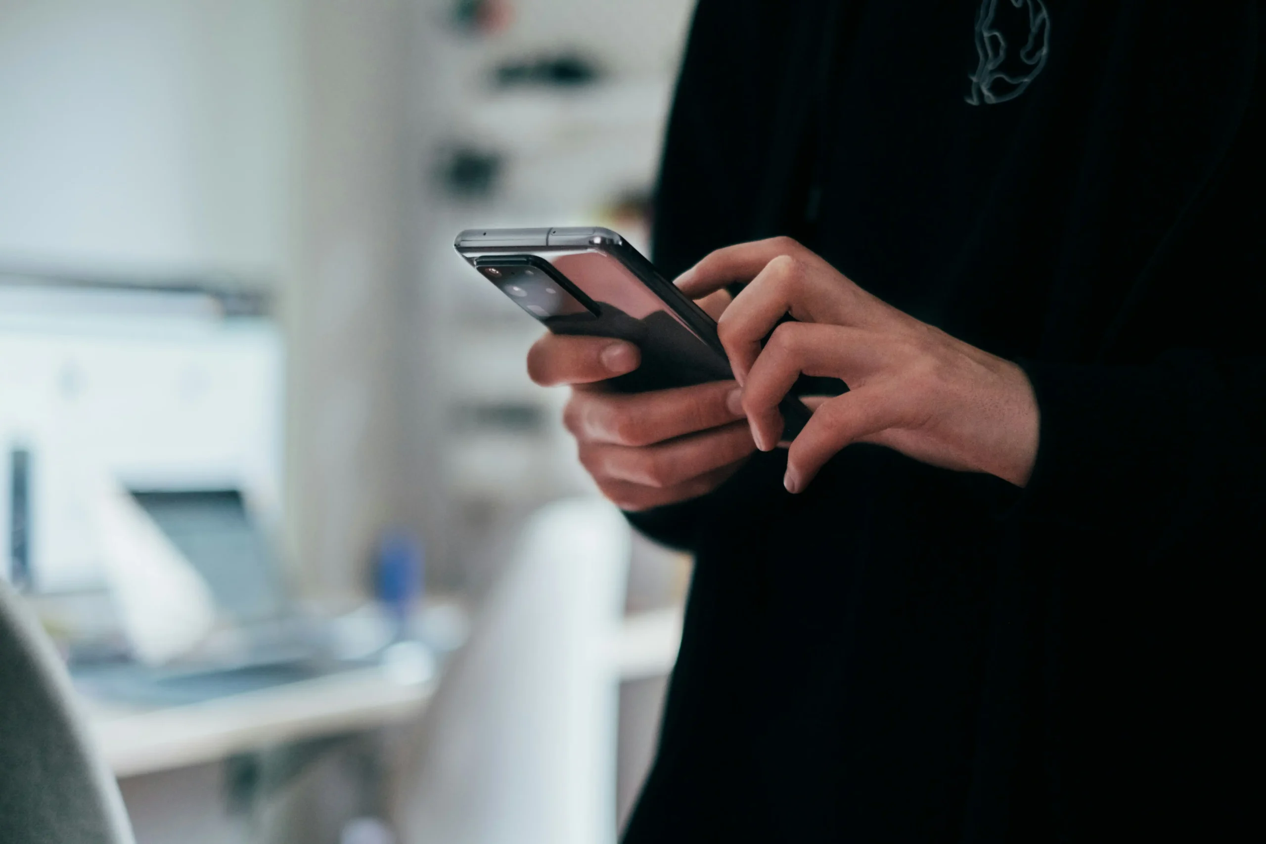 A person typing on a smartphone