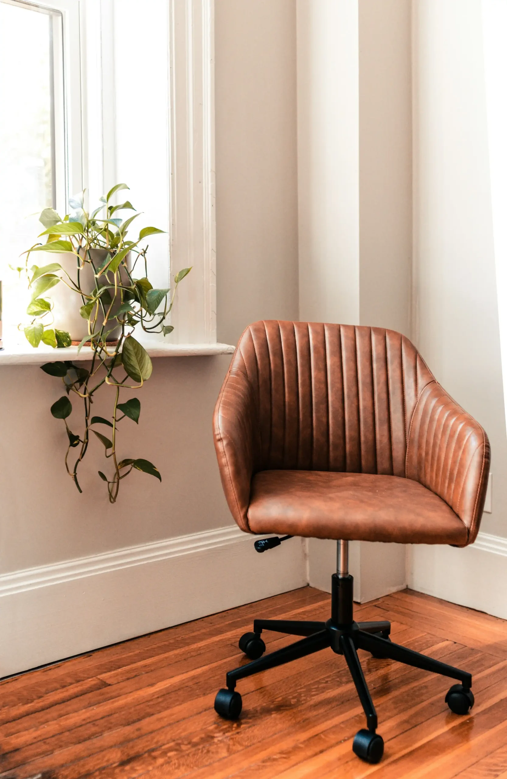 An empty office chair by a window, waiting