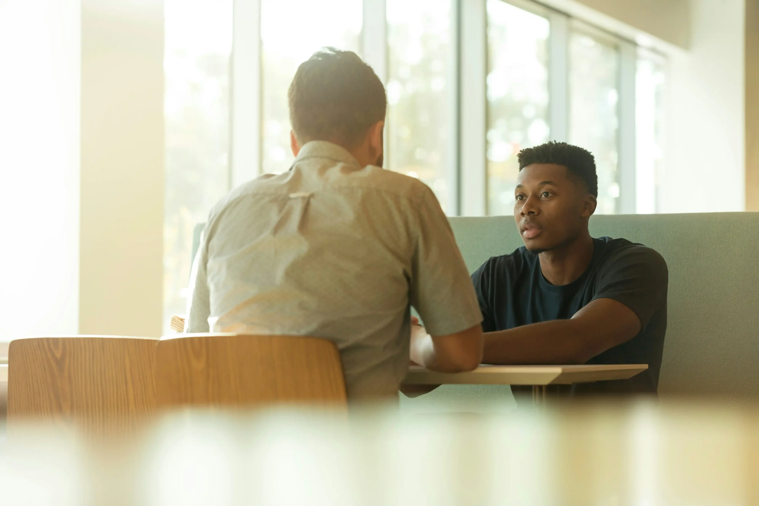 Two people sitting across from each other having a conversation