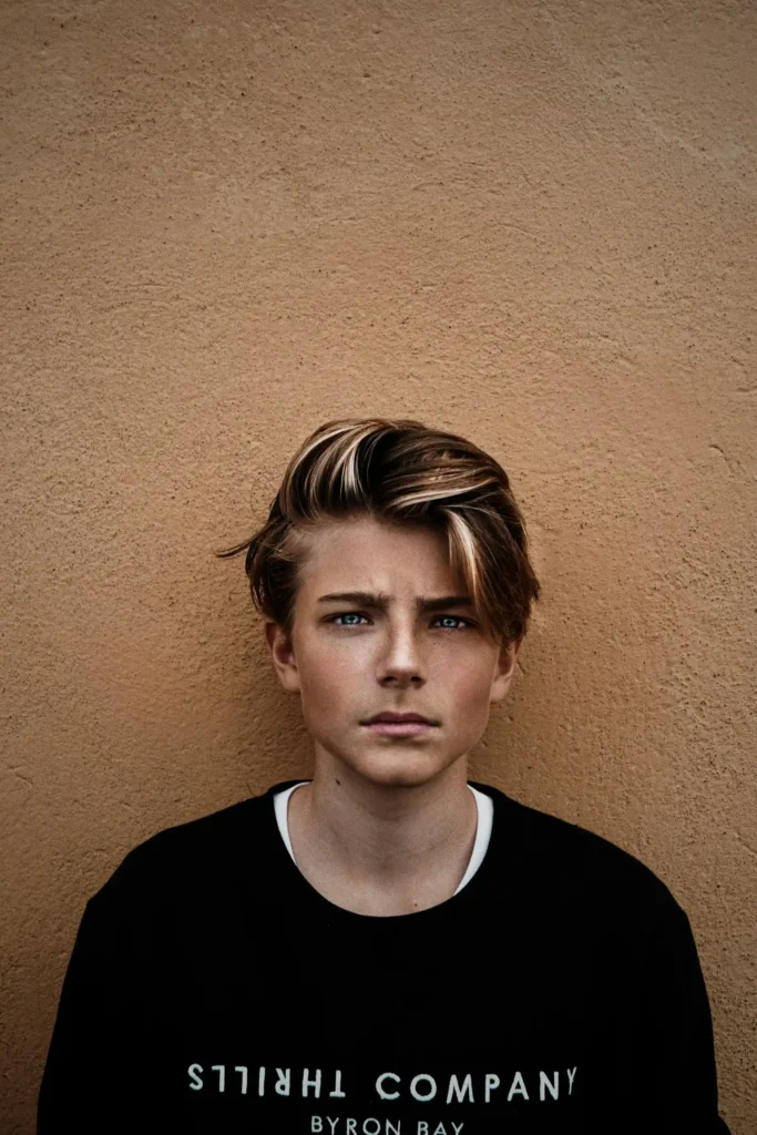 A teen boy looking directly at the camera with a serious expression