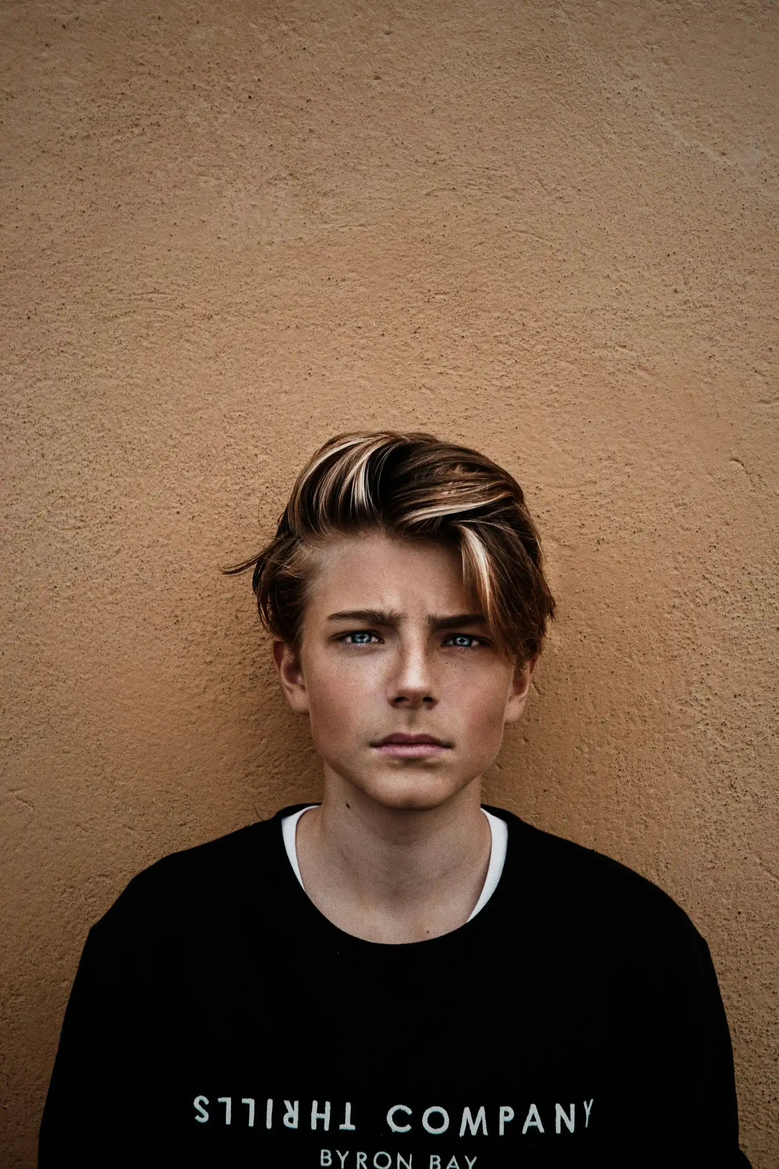 A teen boy looking directly at the camera with a serious expression
