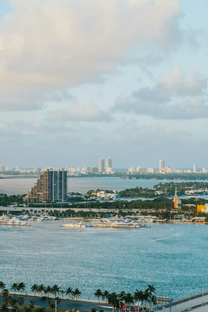 Aerial view of the Miami skyline and marina along Biscayne Bay, lined with palm trees