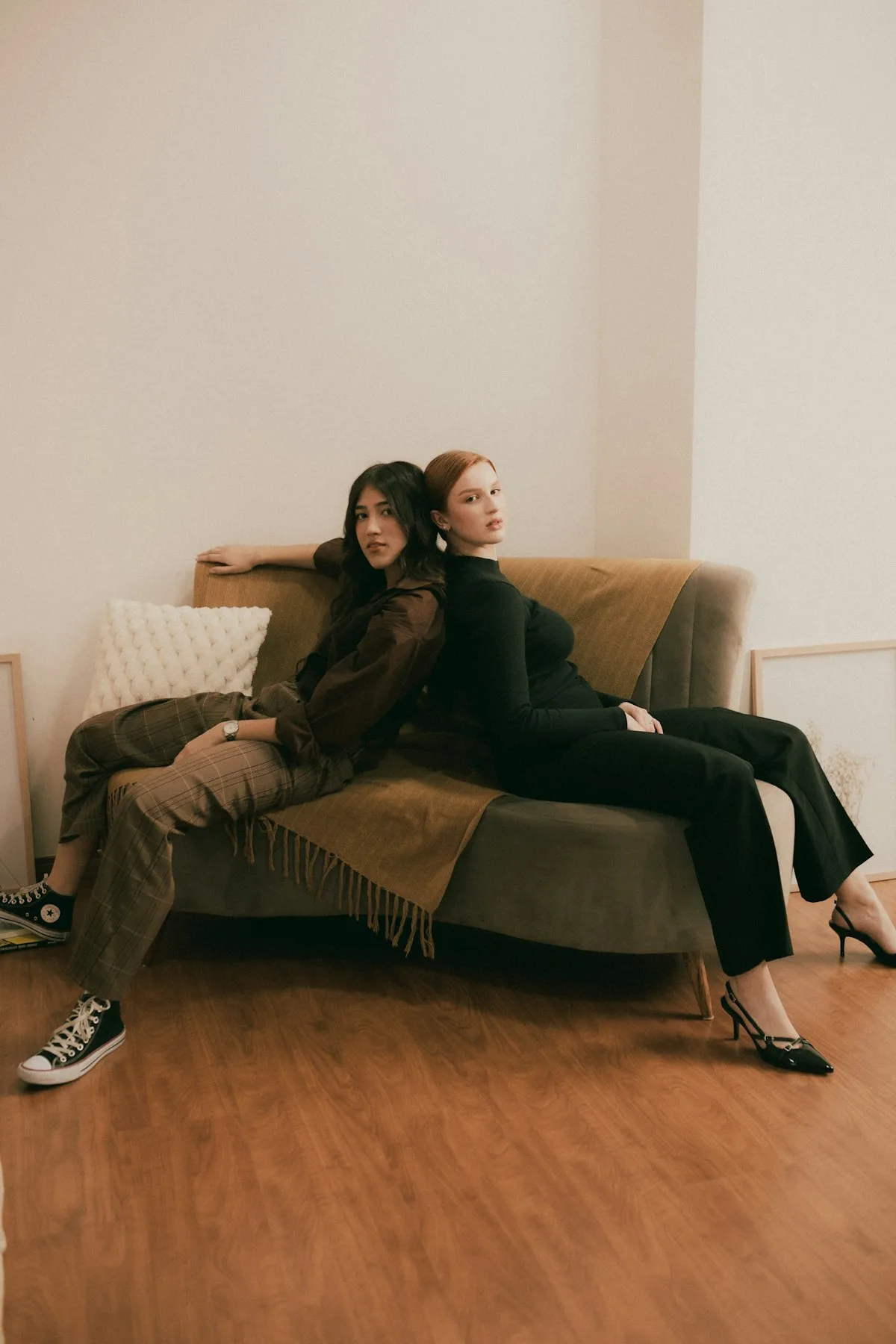 Two women sitting together on a couch