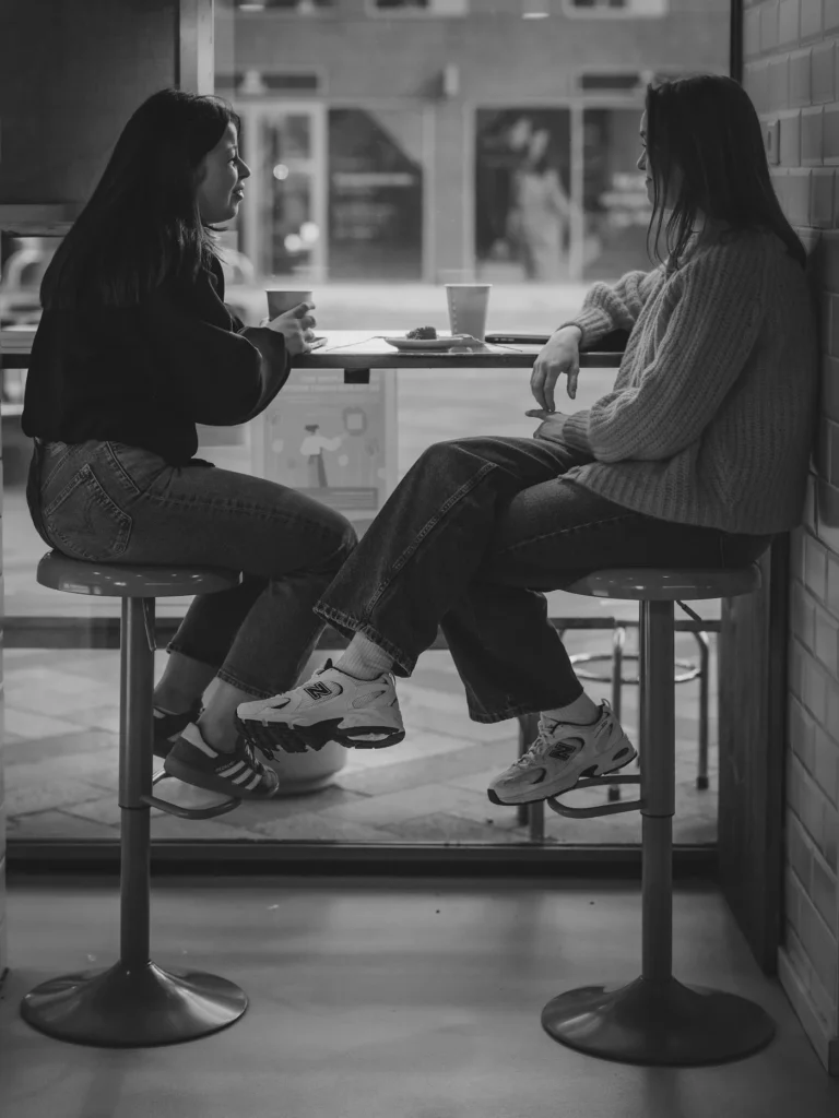 Two women in conversation at a cafe table